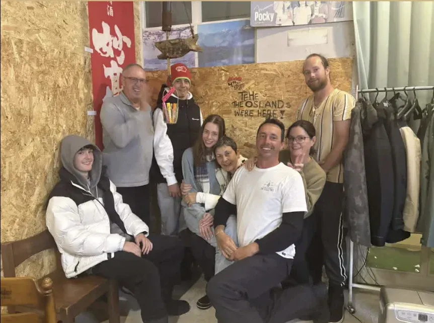 A group gathered beside the NINJA message wall