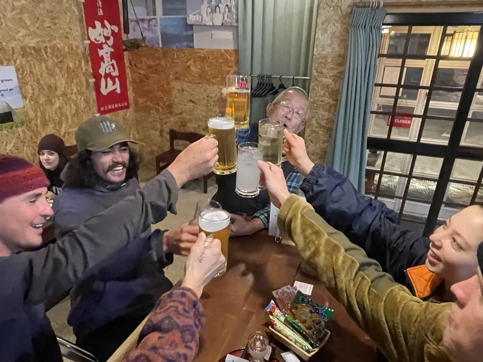 Smiling guests raising their glasses at NINJA